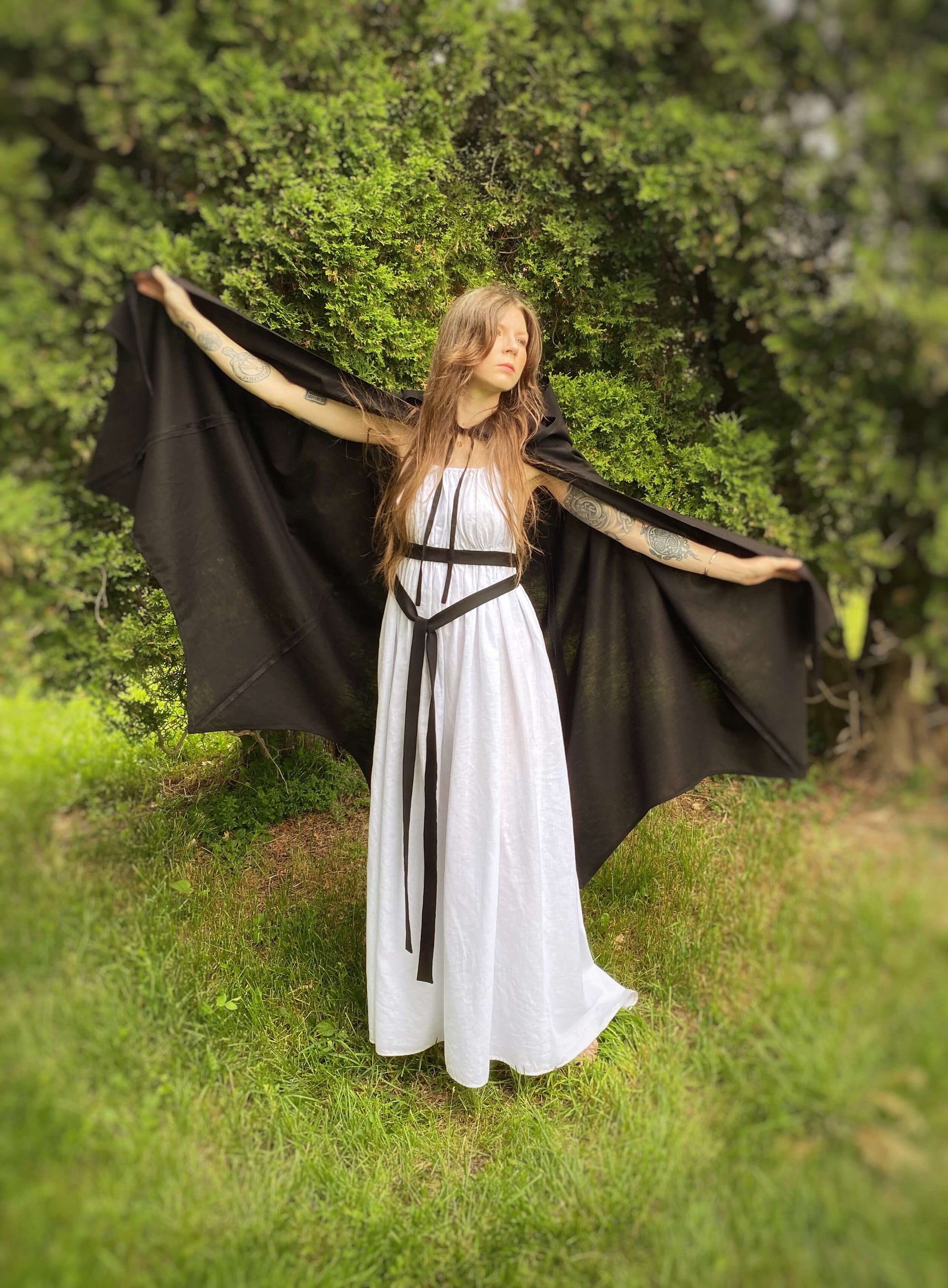 A lightweight, black cape in the shape of bat wings when held open by the finger loops. 