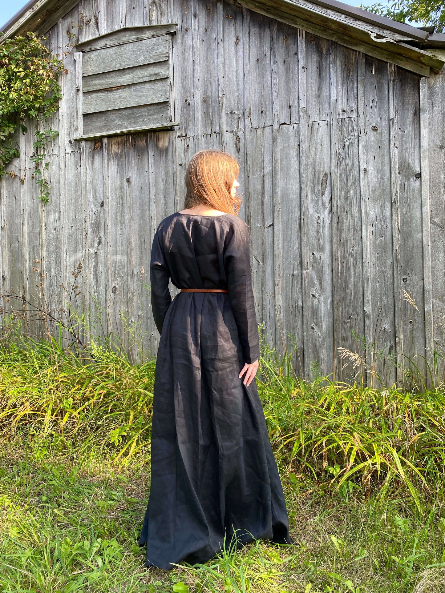 The back view of our long sleeve, iron age tunic dress in black linen. 