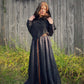 The tunic dress in black linen paired with a black wool norse hood. Hood is up and paired with a thing leather belt.